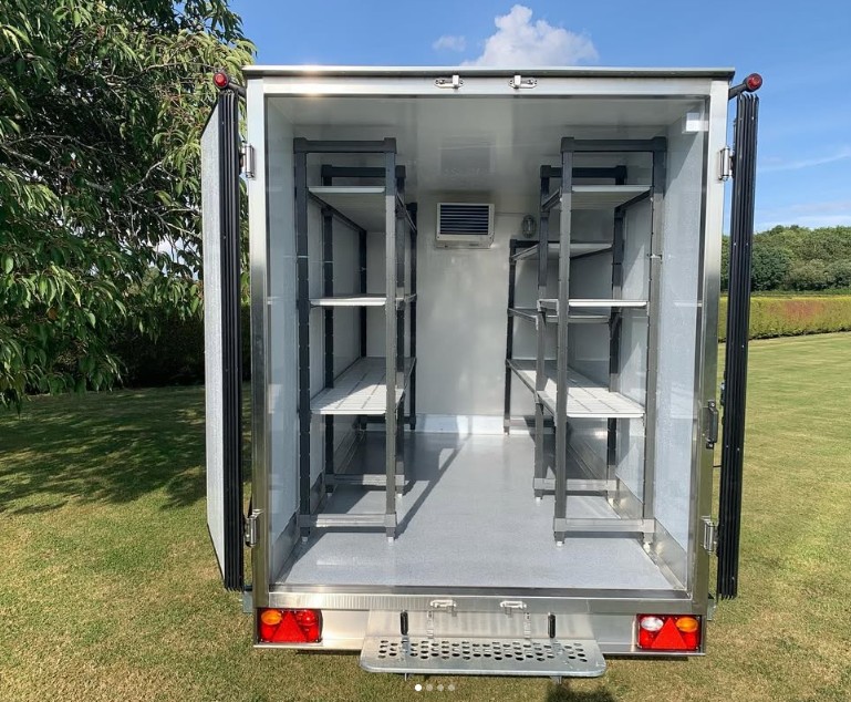 Inside a Chilled Down fridge trailer showing shelving on both sides
