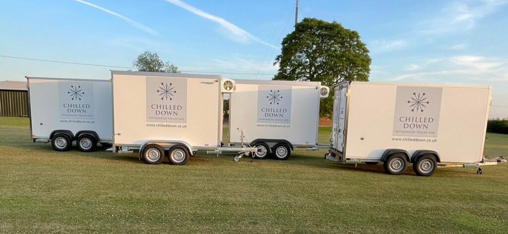 Chilled Down fridge trailers lined up in a field