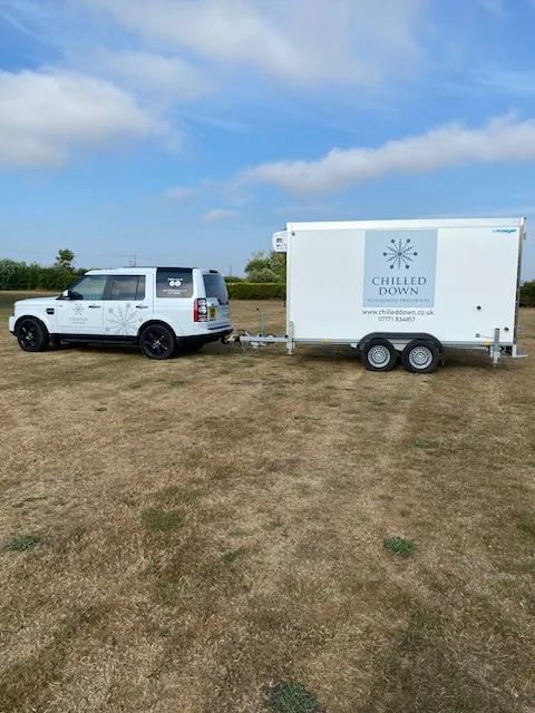 Land Rover Discovery Dolly towing refrigerated trailer at off-road event Fundenhall