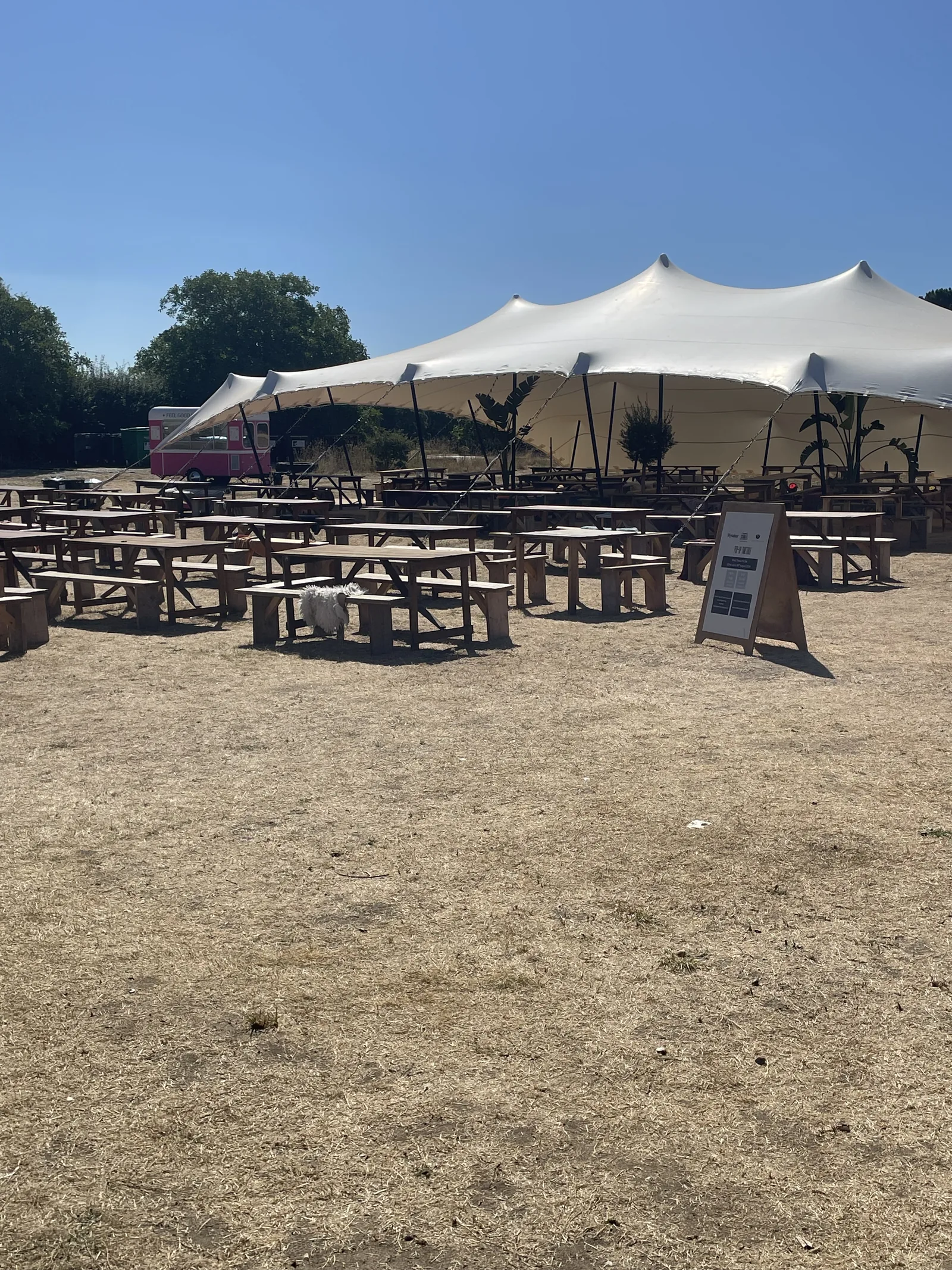 Outdoor seating area under white marquee tent at Wiveton Hall North Norfolk